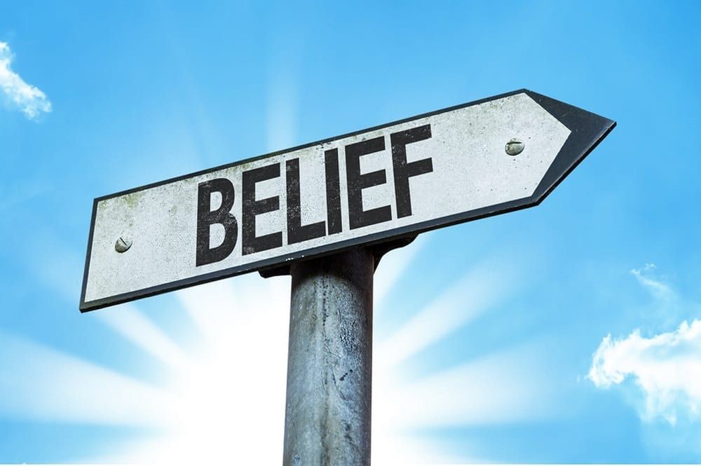 Image of a street sign with the word belief on it