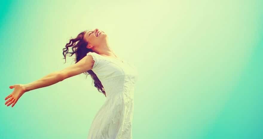 Image of woman smiling with arms wide open