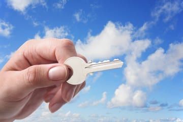 Image of the sky with a hand and key