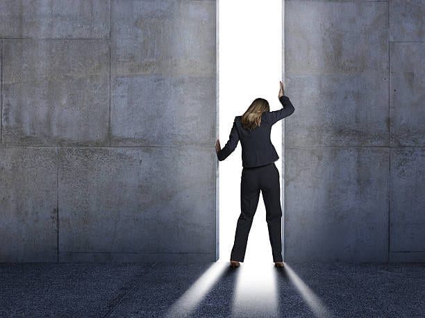 Image of woman pushing concrete walls apart