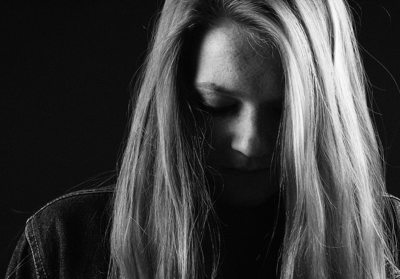 Image of a girl with her head down